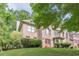 Traditional brick home with manicured lawn, mature trees, arched window and covered entry providing great curb appeal at 709 Eastwood Rise, Stone Mountain, GA 30087