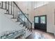 Foyer with a staircase, hardwood floors, and double doors creating an inviting entrance with high ceilings at 709 Eastwood Rise, Stone Mountain, GA 30087