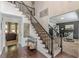 Welcoming foyer with staircase, dark wood floors, high ceilings, and views to other living spaces at 709 Eastwood Rise, Stone Mountain, GA 30087