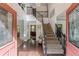 Bright foyer with hardwood floors, high ceilings, staircase, and glass paneled entry doors providing an inviting entrance at 709 Eastwood Rise, Stone Mountain, GA 30087