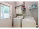 Functional laundry room with a washer, dryer, and ample storage at 709 Eastwood Rise, Stone Mountain, GA 30087