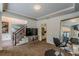 Cozy living room featuring a television, mirrored cabinet, and staircase at 709 Eastwood Rise, Stone Mountain, GA 30087