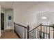 Upstairs landing featuring staircase, pendant light, and railing, offering an airy transition between levels at 709 Eastwood Rise, Stone Mountain, GA 30087