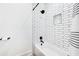 Well-lit bathroom features a modern shower with a tiled backsplash, and white fixtures at 201 Dobbs Rd, Woodstock, GA 30188