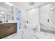Bright primary bathroom showcasing a freestanding tub, glass shower and marble flooring at 201 Dobbs Rd, Woodstock, GA 30188