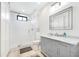 A serene bathroom with a glass-enclosed shower, a marble countertop, and built in storage at 201 Dobbs Rd, Woodstock, GA 30188