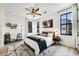 Bright bedroom featuring a ceiling fan, white walls, hardwood floors, and a decorative rug at 201 Dobbs Rd, Woodstock, GA 30188