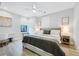 Cozy bedroom featuring a ceiling fan, hardwood floors, modern lighting, and neutral decor at 201 Dobbs Rd, Woodstock, GA 30188