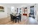Dining area boasts natural light, wooden table with seating, and modern staircase with white walls at 201 Dobbs Rd, Woodstock, GA 30188