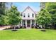 Charming, two-story traditional home with a manicured lawn and a welcoming front porch at 201 Dobbs Rd, Woodstock, GA 30188