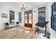 Bright foyer with wood floors, stylish decor, and an abundance of natural light at 201 Dobbs Rd, Woodstock, GA 30188