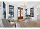Sunlit foyer with stylish furnishings and a beautiful wood floor design at 201 Dobbs Rd, Woodstock, GA 30188