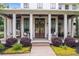 Inviting front porch with comfortable seating and stylish decor of the home at 201 Dobbs Rd, Woodstock, GA 30188