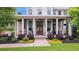 Inviting front porch with stylish columns, seating, and landscaping, creating a welcoming entrance to the home at 201 Dobbs Rd, Woodstock, GA 30188