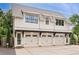 Spacious three-car garage with white doors, modern lighting, and ample parking space at 201 Dobbs Rd, Woodstock, GA 30188