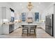 Stylish kitchen with white cabinetry, an island with seating, and stainless steel appliances at 201 Dobbs Rd, Woodstock, GA 30188