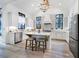 Bright kitchen features white cabinets, large windows, stainless appliances, and a marble island with seating at 201 Dobbs Rd, Woodstock, GA 30188