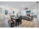 Open living space with kitchen, dining, and living areas featuring hardwood floors and natural light at 201 Dobbs Rd, Woodstock, GA 30188