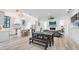 Open-concept living space with a modern kitchen, dining area, and cozy fireplace at 201 Dobbs Rd, Woodstock, GA 30188