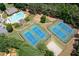 Aerial view of neighborhood amenities including pool, tennis courts, playground, and basketball court surrounded by lush greenery at 5034 Kingsbridge Pass, Powder Springs, GA 30127