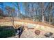 Private backyard with patio and outdoor seating, featuring a fire pit and play set for Gathering fun at 5034 Kingsbridge Pass, Powder Springs, GA 30127