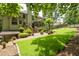 Inviting backyard with lush lawn, stone patio, mature trees, and a charming fire pit area at 5034 Kingsbridge Pass, Powder Springs, GA 30127