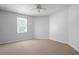Basement features carpet, a ceiling fan, and a window at 5034 Kingsbridge Pass, Powder Springs, GA 30127