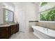 Bright bathroom featuring a soaking tub and granite countertops at 5034 Kingsbridge Pass, Powder Springs, GA 30127