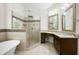 Modern bathroom features a glass shower, soaking tub, and granite countertops at 5034 Kingsbridge Pass, Powder Springs, GA 30127