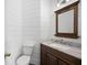 Half bath with a vanity and decorative wall paneling at 5034 Kingsbridge Pass, Powder Springs, GA 30127