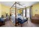 Bright bedroom with a canopy bed, yellow walls, and natural lighting at 5034 Kingsbridge Pass, Powder Springs, GA 30127