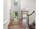 Bright, airy foyer with soaring ceilings, hardwood floors, and a staircase leading to the upper level at 5034 Kingsbridge Pass, Powder Springs, GA 30127