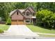 Beautiful two-story brick home features a well-kept lawn, mature trees, and a convenient two-car garage at 5034 Kingsbridge Pass, Powder Springs, GA 30127