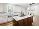 Beautiful kitchen featuring an island, stainless sink, and white subway tile backsplash at 5034 Kingsbridge Pass, Powder Springs, GA 30127