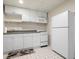 Basement kitchenette featuring white cabinets, counters, and appliances at 5034 Kingsbridge Pass, Powder Springs, GA 30127