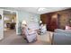 Comfortable living room with wood accent wall open to dining area and kitchen at 5034 Kingsbridge Pass, Powder Springs, GA 30127