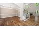 Open living room with hardwood floors, a staircase, and an elegant chandelier over the dining area at 5034 Kingsbridge Pass, Powder Springs, GA 30127