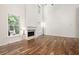 Bright living room with hardwood floors and a cozy fireplace at 5034 Kingsbridge Pass, Powder Springs, GA 30127