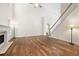 Spacious living room with hardwood floors, fireplace, and staircase at 5034 Kingsbridge Pass, Powder Springs, GA 30127