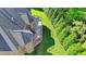 An aerial view depicts a patio adjacent to the tree line and the home's roof at 8340 Royal Melbourne Way, Duluth, GA 30097