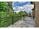 Spacious balcony with tile flooring and wrought iron railings, offering serene views of the surrounding greenery at 8340 Royal Melbourne Way, Duluth, GA 30097