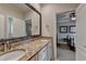 Bathroom with granite counters and a large mirror over double sinks plus decoratively framed mirror at 8340 Royal Melbourne Way, Duluth, GA 30097