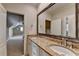 Bathroom with a double sink vanity with light colored granite and a decorative mirror at 8340 Royal Melbourne Way, Duluth, GA 30097