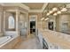 Spacious bathroom with double vanity, tile flooring, glass shower and soaking tub at 8340 Royal Melbourne Way, Duluth, GA 30097