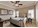 Cozy bedroom with a queen-size bed, ceiling fan, neutral decor, and natural light from shuttered windows at 8340 Royal Melbourne Way, Duluth, GA 30097