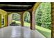 Picturesque covered patio with brick arches and manicured lawn, perfect for outdoor entertaining at 8340 Royal Melbourne Way, Duluth, GA 30097