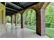 Covered patio with brick arches and green lawn perfect for outdoor relaxation at 8340 Royal Melbourne Way, Duluth, GA 30097