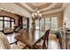 Formal dining room with a coffered ceiling, large windows, and elegant furnishings, perfect for entertaining guests at 8340 Royal Melbourne Way, Duluth, GA 30097