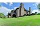 Beautiful two-story brick home with manicured landscaping and a balcony at 8340 Royal Melbourne Way, Duluth, GA 30097