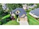 Aerial view of a traditional two-story home, featuring stone and siding, a manicured lawn, and an attached two-car garage at 8340 Royal Melbourne Way, Duluth, GA 30097